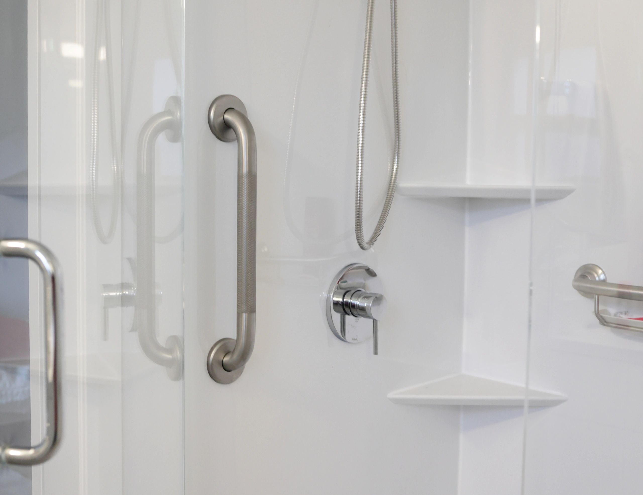 Accessible shower upgrade with grab bar and modern wall panels