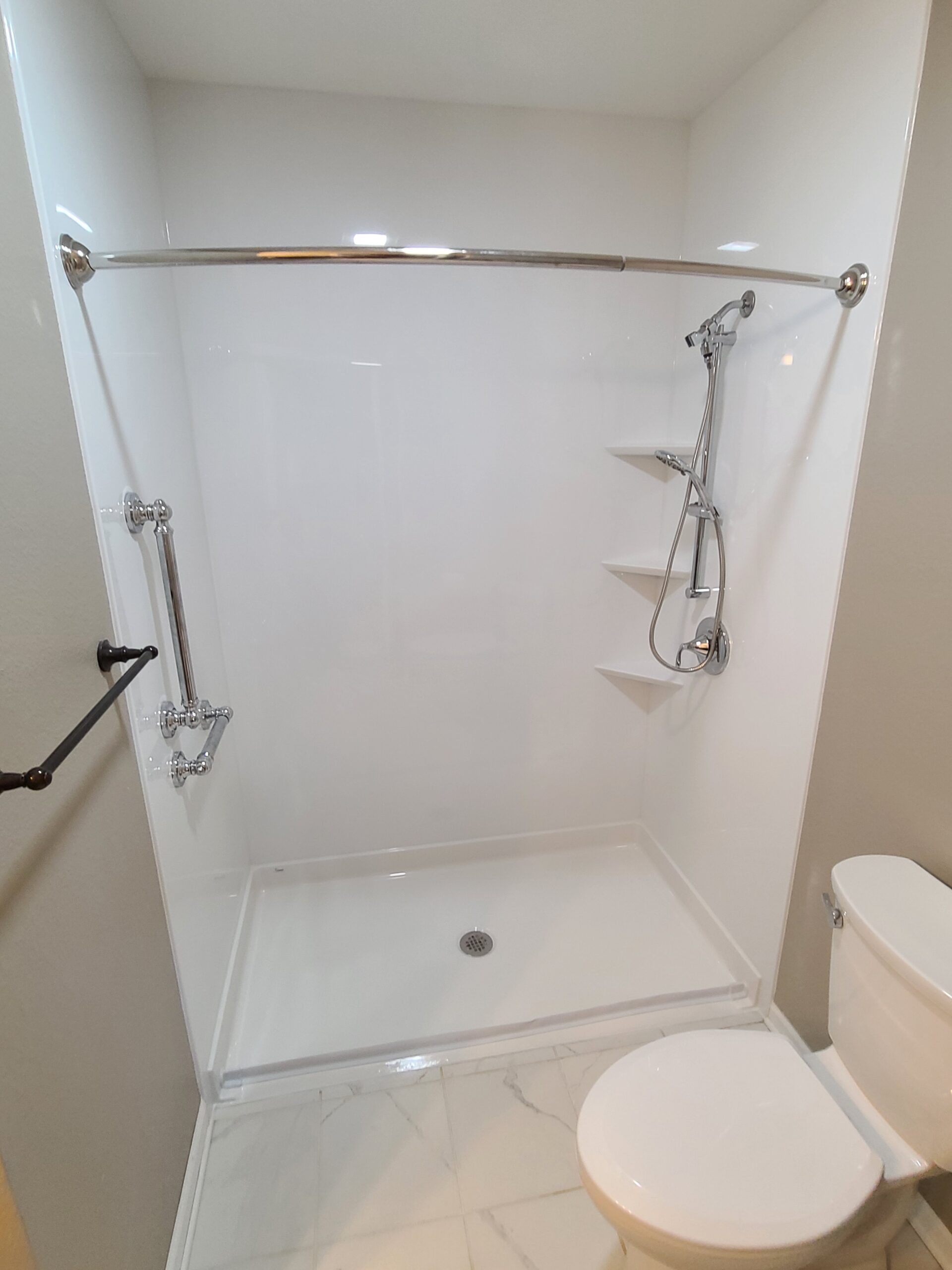 Bathroom renovation showing finished shower conversion