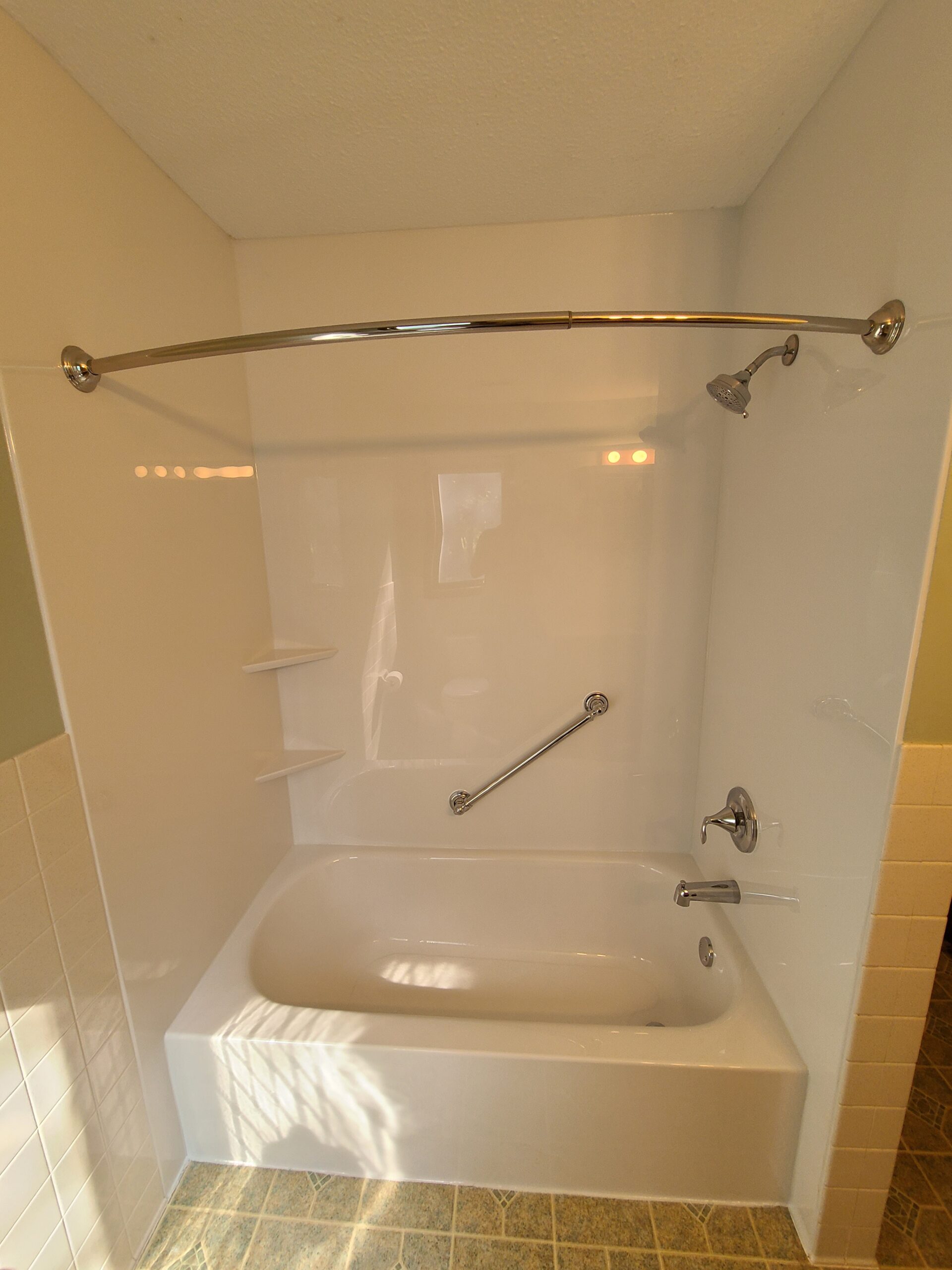 Completed tub-to-shower conversion in a residential bathroom