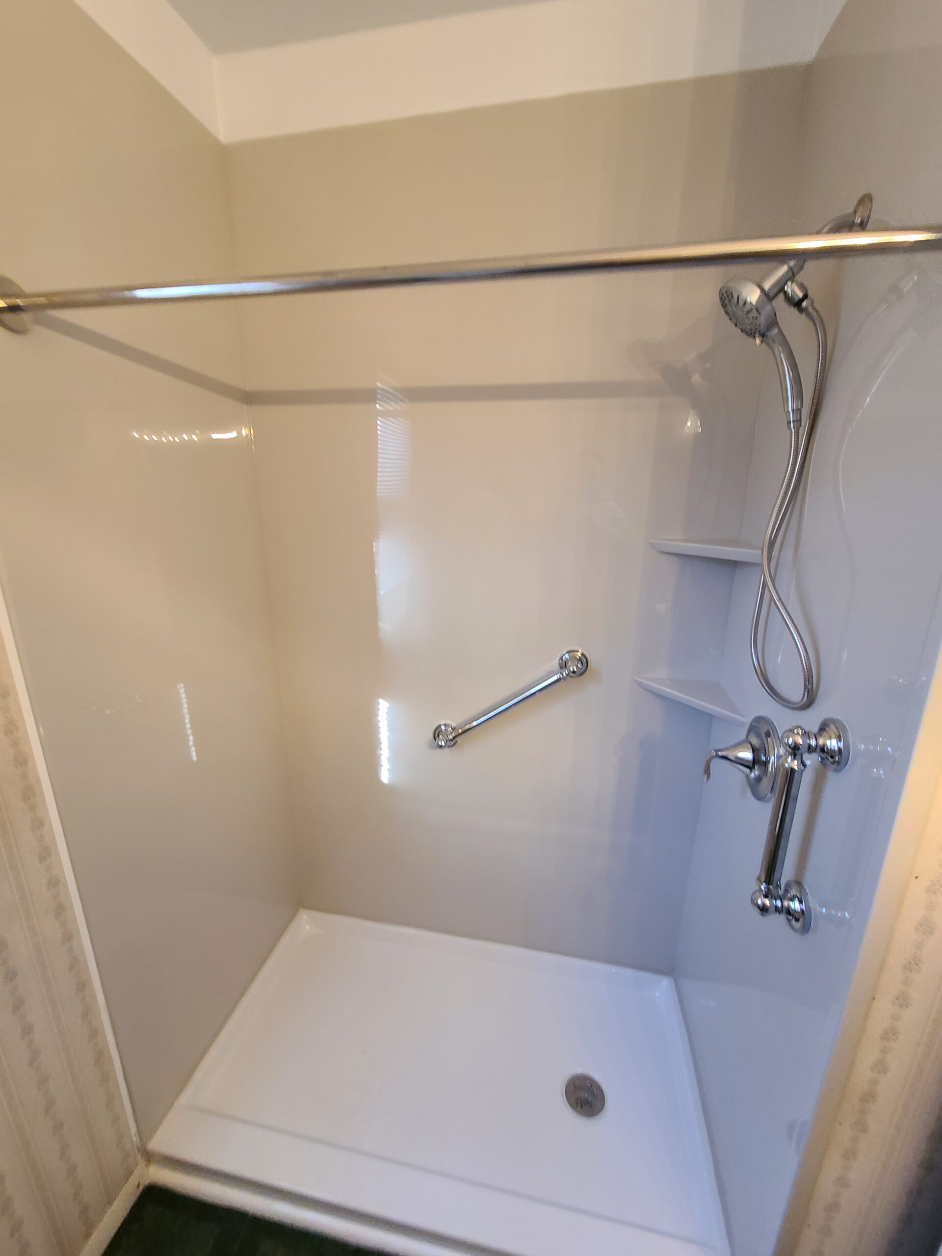 Remodeled bathroom with walk-in shower and bright walls